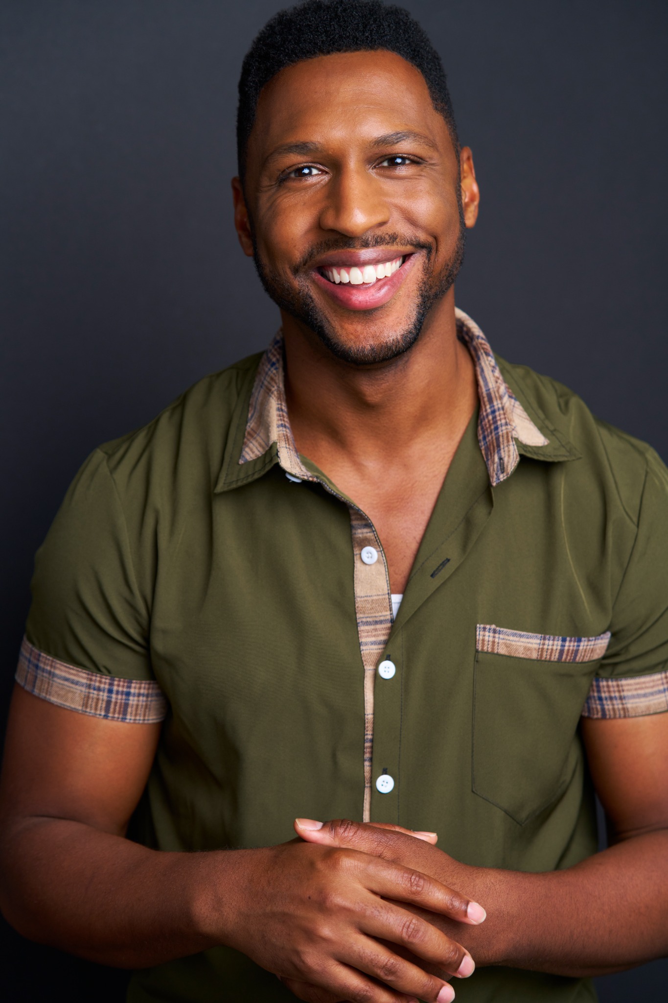 Professional headshot of Javar La’trail Parker smiling